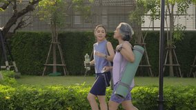 Young adult child and mature middle age old mum public park walk workout with yoga mat water bottle. Love health care older mom asia elder people happy protect aging life enjoy sport club class active - Powered by Shutterstock - Get 15% off with code: PIKWIZARD15