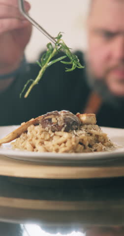 Person, hands and chef with garnish on plate for meal presentation, culinary art or hospitality at home. Closeup, cook or catering service with ingredient for fine dining, gourmet dish or cuisine