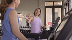 Young active adult child and mature middle age old mum run walk advice workout at gym. Love mental health care older retired mom asia elder people happy protect aging life balance enjoy sport club. - Powered by Shutterstock - Get 15% off with code: PIKWIZARD15