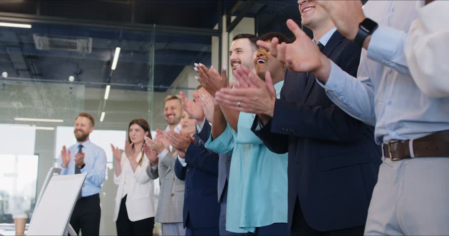 Large and diverse group of satisfied business people are smiling, laughing and applauding after speaker or business trainer's presentation at the end of conference, workshop or business training event