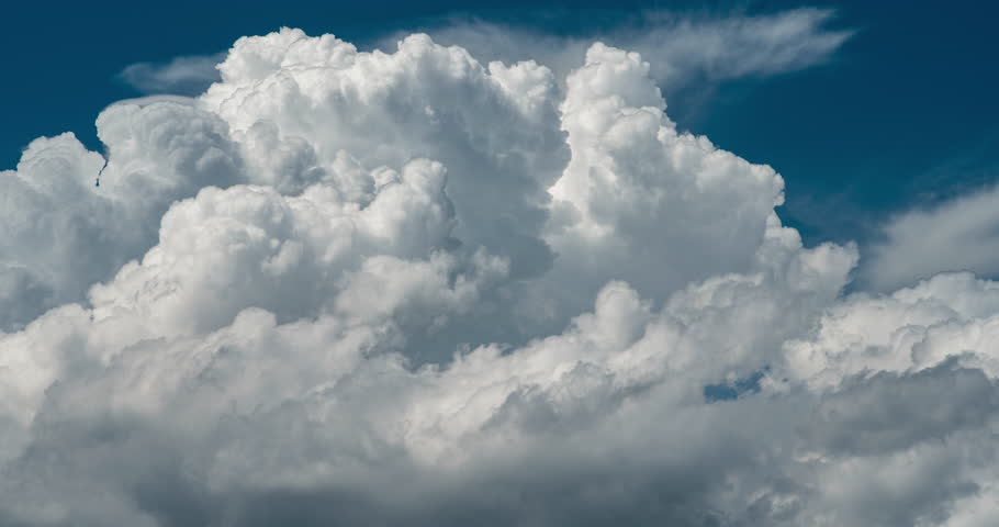 Timelapse of thick puffy clouds forming in the blue sky