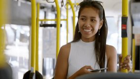 Woman holding handrail and browsing smartphone on city bus, displaying technology network overlay. Public transport, urban mobility, connectivity, digital network, commuter, travel, modern design - Powered by Shutterstock - Get 15% off with code: PIKWIZARD15