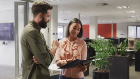 coworkers discussing business data with HUD overlay while using tablet and clipboard in office. Collaboration, communication, technology, innovation, modern, professional, productivity - Powered by Shutterstock - Get 15% off with code: PIKWIZARD15