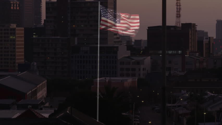 American flag waving on rooftop vista, cityscape towering behind under dusky sky in 3D render. Patriotism, skyline, urban, architecture, dusk, modern, height