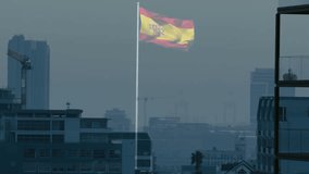 Spanish flag waving atop pole over hazy urban skyline showing cranes, palm tree in flat design. Patriotic, skyline, architecture, urban, civic, government, emblem - Powered by Shutterstock - Get 15% off with code: PIKWIZARD15