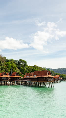 timelapse of paradise bungalows over the sea in langkawi malaysia in vertical