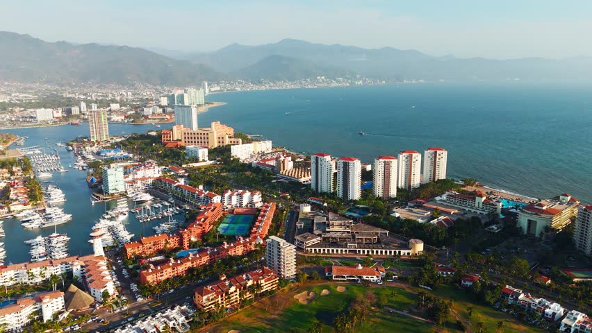 Breathtaking aerial panorama of puerto vallarta, mexico, showcasing hotels, beaches, and the vast pacific ocean during a vibrant sunset
