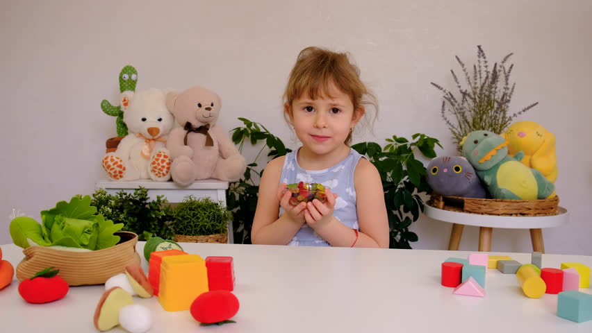 Child with jelly candies. Selective focus.