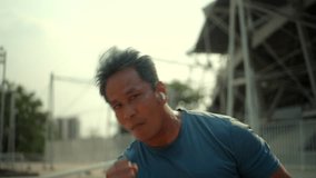 Active happy senior fit man in sportswear smiling confidently and boxing workout outdoor in the city park, mature man staying healthy and exercise outdoor sporty lifestyle.
 - Powered by Shutterstock - Get 15% off with code: PIKWIZARD15