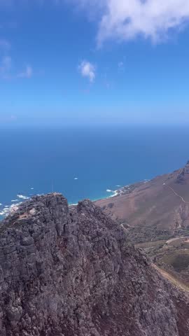 Scenic ride in a rotating cable car ascending Table Mountain in Cape Town, South Africa. Clear view of the rocky landscape and sky. No people visible.