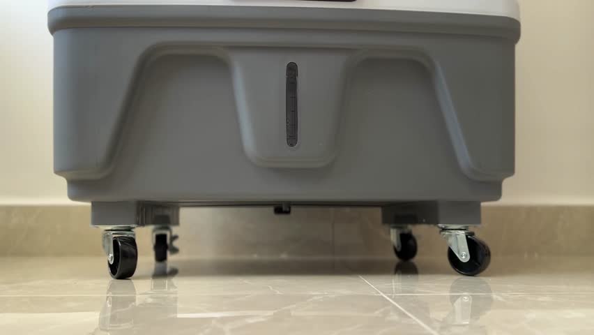 4K footage showing the smooth movement of sliding wheels on an air cooler. Ideal for appliance mobility, home gadget features, and cooling equipment visuals.