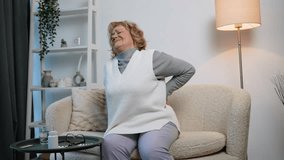 Elderly woman suffering from severe back pain at home - Powered by Shutterstock - Get 15% off with code: PIKWIZARD15