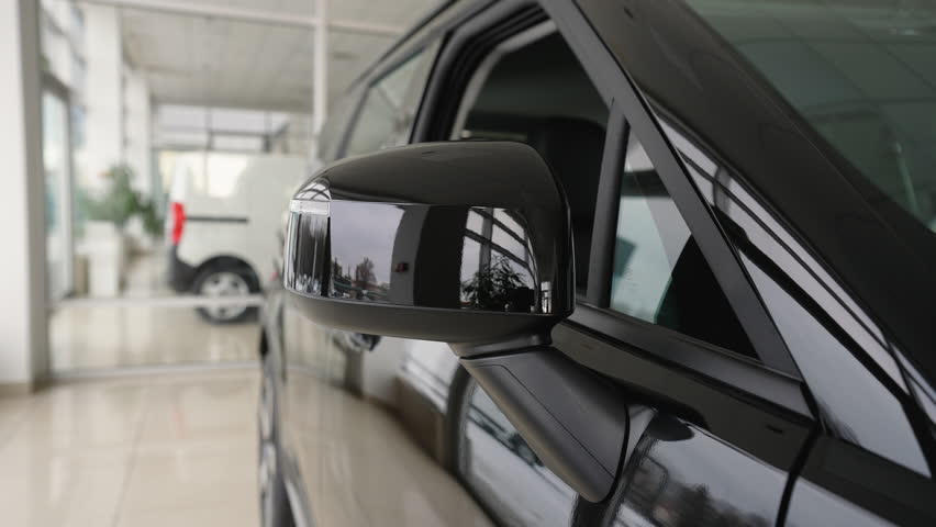 Folding side mirror on a new car in the dealership