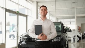 Confident car salesman with clipboard in modern dealership - Powered by Shutterstock - Get 15% off with code: PIKWIZARD15
