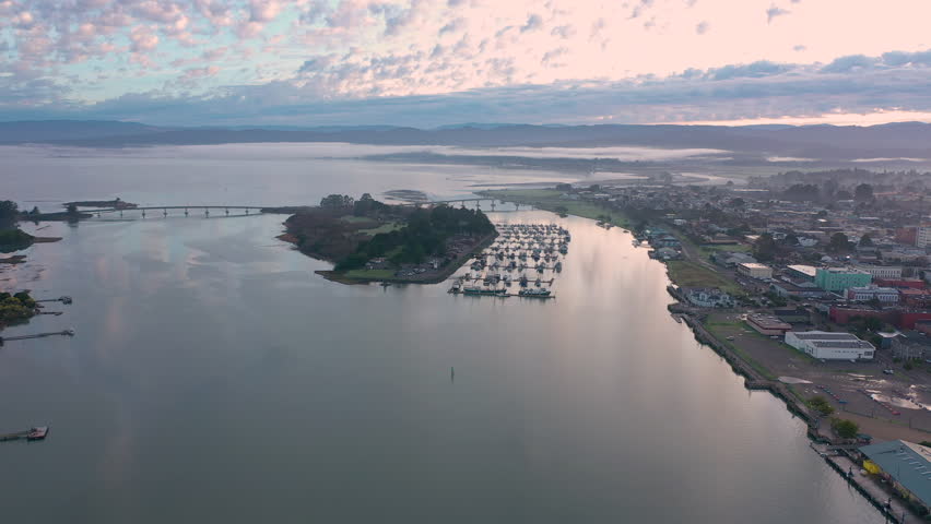 Humboldt Bay and Marina with fishing boats in Eureka, California. Drone view at sunrise.