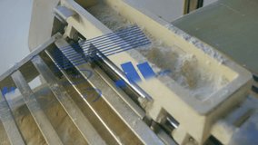 Raw dough sliding on steel slats, showing floating blue charts and percentages in flat design. Bakery, foodtech, industrial, precision, manufacturing, digital, baking - Powered by Shutterstock - Get 15% off with code: PIKWIZARD15