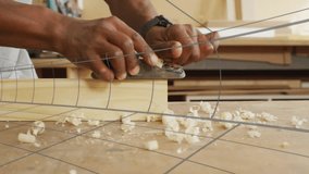 Woodworking pro smoothing plank using hand plane, animated shavings swirling around gauge overlays. Craftsmanship, woodworking, artisan, carpentry, tradition, manual, craft - Powered by Shutterstock - Get 15% off with code: PIKWIZARD15