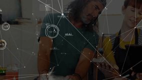 Team members examining tablet in workshop, showing technology network nodes and waveform charts. Collaboration, innovation, data visualization, digital design, creative teamwork, diy, modern workspace - Powered by Shutterstock - Get 15% off with code: PIKWIZARD15