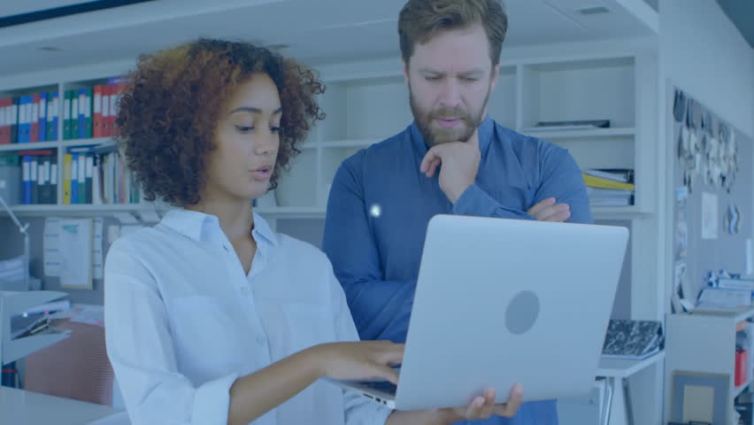 Man pointing at laptop while woman listening in tech office, displaying network node overlay. Collaboration, teamwork, innovation, technology, data, networking, modern - Powered by Shutterstock - Get 15% off with code: PIKWIZARD15