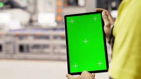 Solar panels plant technician uses green screen tablet to oversee systems. Photovoltaics plant employee uses software on chroma key device to maintain operations, camera B close up - Powered by Shutterstock - Get 15% off with code: PIKWIZARD15