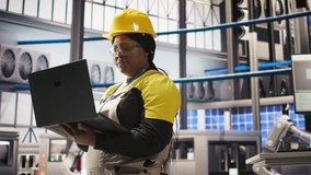 Specialist using laptop to conduct routine inspections in industry 4.0 plant producing renewable energy. Technician in photovoltaics smart factory testing equipment using notebook, camera A - Powered by Shutterstock - Get 15% off with code: PIKWIZARD15