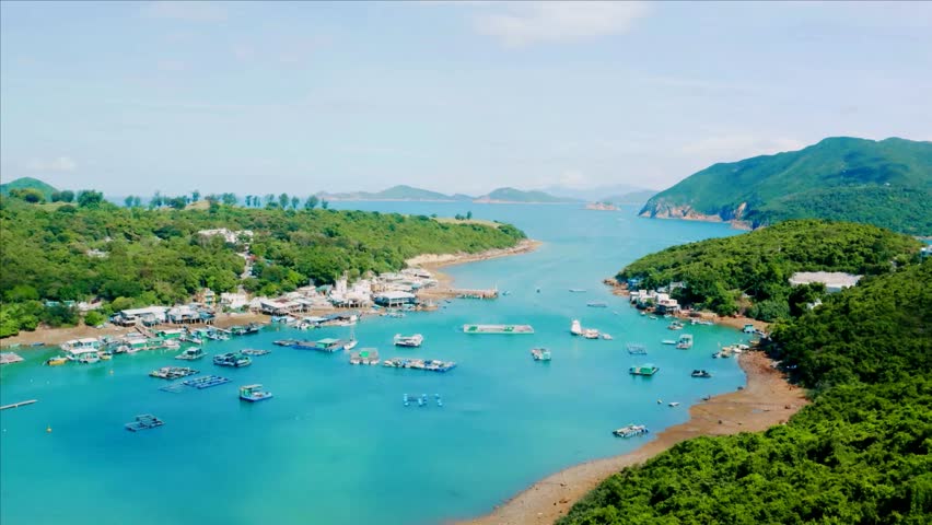 Aerial View of Coastal Village and Boats in Turquoise Bay