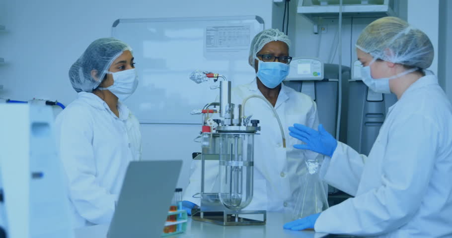 Female scientists conducting biotech research in lab, displaying bioreactor with blue data overlay. Biotechnology, innovation, science, technology, research, laboratory, molecular