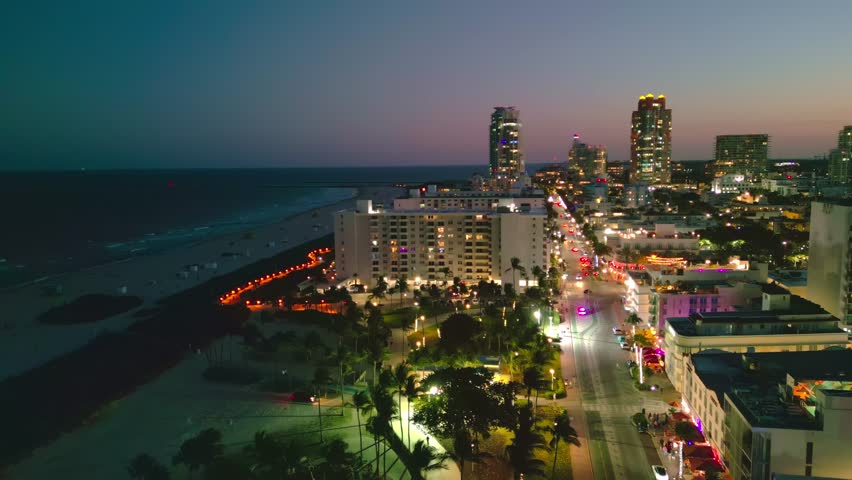Miami Beach, Ocean Drive at night. Miami Ocean Drive seaside at dusk. Aerial view of night Miami Beach and cityscape of Ocean Drive. Ocean Drive of Miami Beach night shot from the air drone.