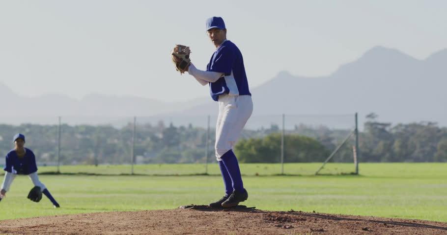 woman pitcher pitching beside ready fielder on baseball park in tech scene with floating 5G bubbles. Athletics, teamwork, sports, outdoor, youth, motion, athleticwear