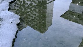 Urban Building Reflections in Puddle on Concrete Ground - Powered by Shutterstock - Get 15% off with code: PIKWIZARD15