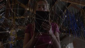 female mechanic reviewing tablet in workshop, displaying technology network lines over tools. Technology, automation, industrial, innovation, engineering, connectivity, productivity - Powered by Shutterstock - Get 15% off with code: PIKWIZARD15