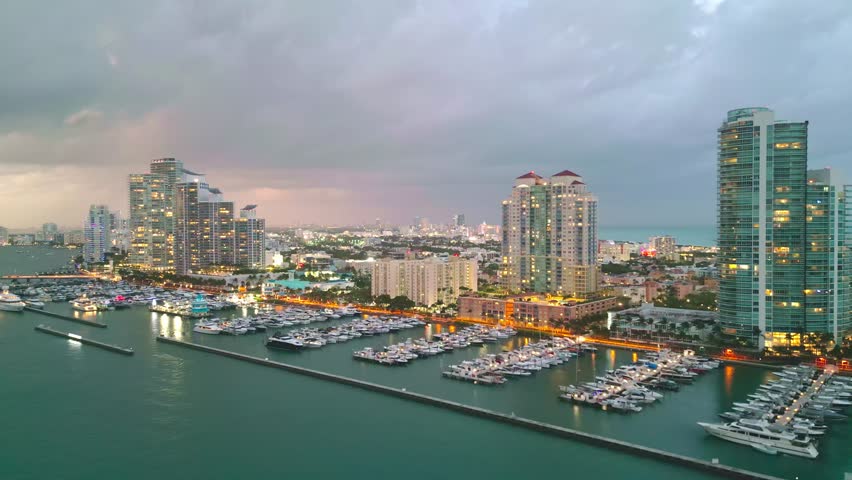 Miami Beach, South Beach at night with dramatic sky. Miami seaside at dusk. Aerial view of evening Miami Beach and cityscape. Coastline of Miami Beach sunset shot from the air drone.