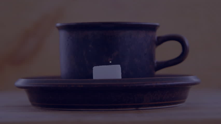 dark ceramic coffee cup with sugar cube resting on wood table, glowing 3D overlay forming link. Luxury, minimalism, technology, comfort, warmth, elegance, hospitality