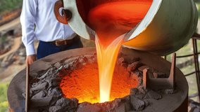 Molten Metal Pouring Into a Crucible. This video shows a worker pouring molten metal from a ladle into a crucible. The metal is glowing red-hot and the scene is intense. - Powered by Shutterstock - Get 15% off with code: PIKWIZARD15