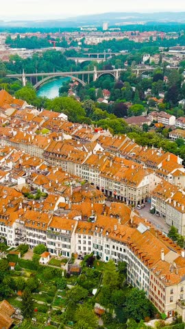 Vertical video. Bern, Switzerland. Bern Cathedral. Panorama of the city with a view of the historical center. Summer morning, Aerial View. Rich colors