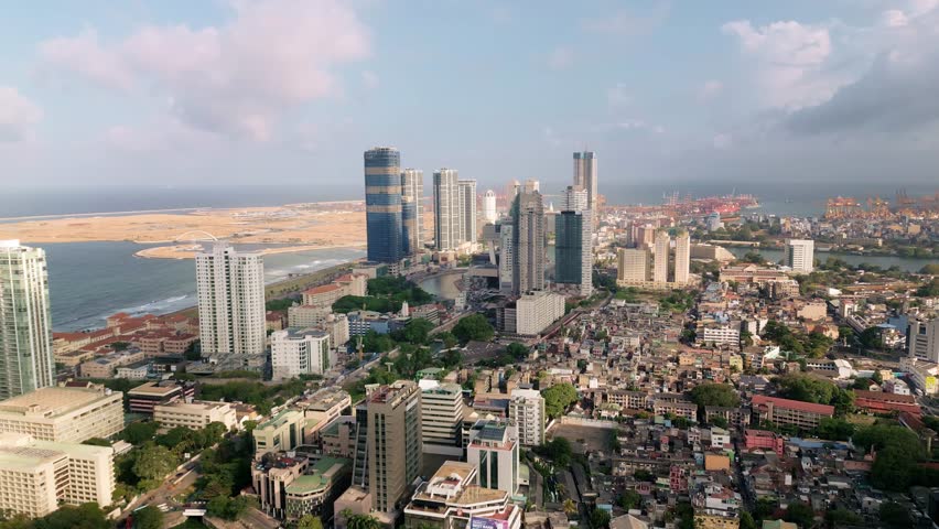 High quality drone footage of Colombo, Sri Lanka showing the city s modern business centre and bustling container port, ideal for corporate, travel, and investment promo content.