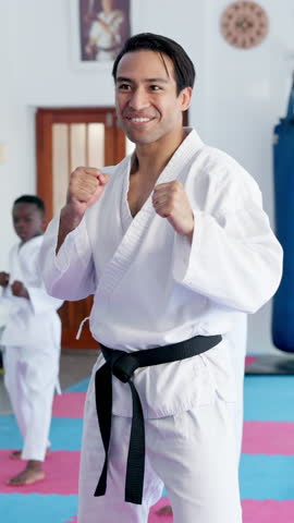 Instructor, training and teaching kids karate in class for combat sports, self defense or fitness. Students, man or learning martial arts in lesson, exercise or teacher practice with children in dojo