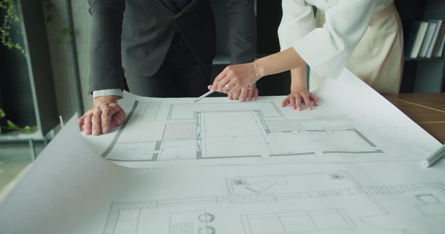 Businesspeople analyzing architectural drawings. 4k video