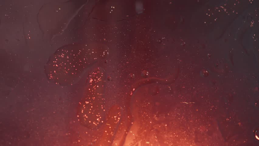 Red orange glow lava lamp style rises with warm light changing to cool blue with oil slicks and shimmering sparkles