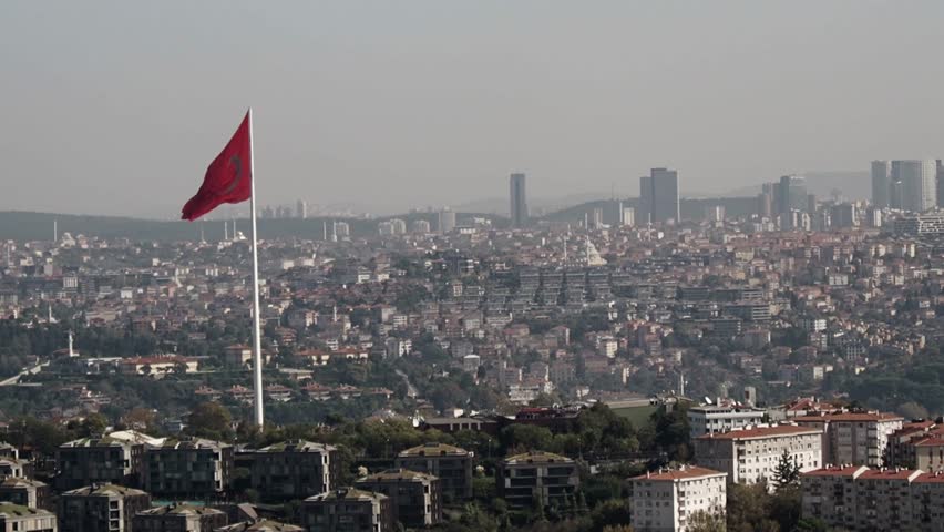 View of city skyline with large flag and urban landscape