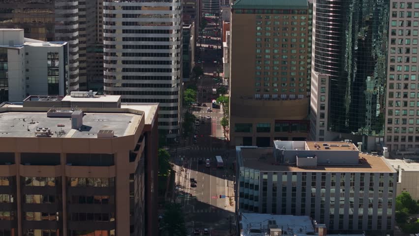 Aerial view of a street in Downtown Denver, surrounded by tall skyscrapers.