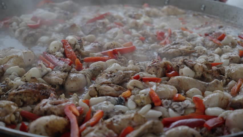 Fried chicken wings sizzle in a pan, filling the kitchen with savory aroma