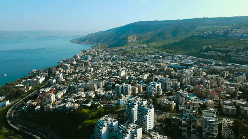 Tiberias and the Sea of ​​Galilee in an amazing drone shot, at sunset.
The Galilee and Golan mountains in the background, the Sea of ​​Galilee is blue and everything around is green.