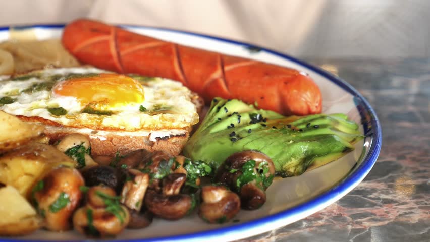 Delicious breakfast platter with eggs, sausage, and mushrooms