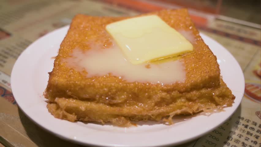 Hong Kong-style French toast consists of deep-fried bread, peanut butter, butter, and condensed milk. This dish is a part of Hong Kong's everyday culinary breakfast or tea set and is a local favorite.