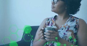 Woman holding mug on sofa, analyzing tech data overlays with holographic charts and brain graphic. Futuristic, innovation, technology, analysis, neural, networking, scientist - Powered by Shutterstock - Get 15% off with code: PIKWIZARD15