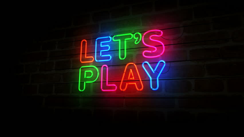 Let's play game neon symbol on brick wall. Lets play gaming light color bulbs abstract concept.