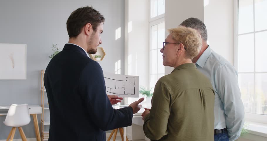 Confident real estate agent, lawyer, realtor speaking to senior, financial advisor giving consultation elder, legal advice to senior couple of clients about new flat, house buying or selling, repair