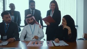Multicultural business team with arab professionals engaging in video conference, discussing strategy with ceo on large screen in modern conference room. - Powered by Shutterstock - Get 15% off with code: PIKWIZARD15