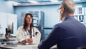 Skilled medical expert analyzing x ray scans for old patient on insurance, discussing with senior patient about protection and prevention for wellbeing. Professional advice. Camera B. - Powered by Shutterstock - Get 15% off with code: PIKWIZARD15